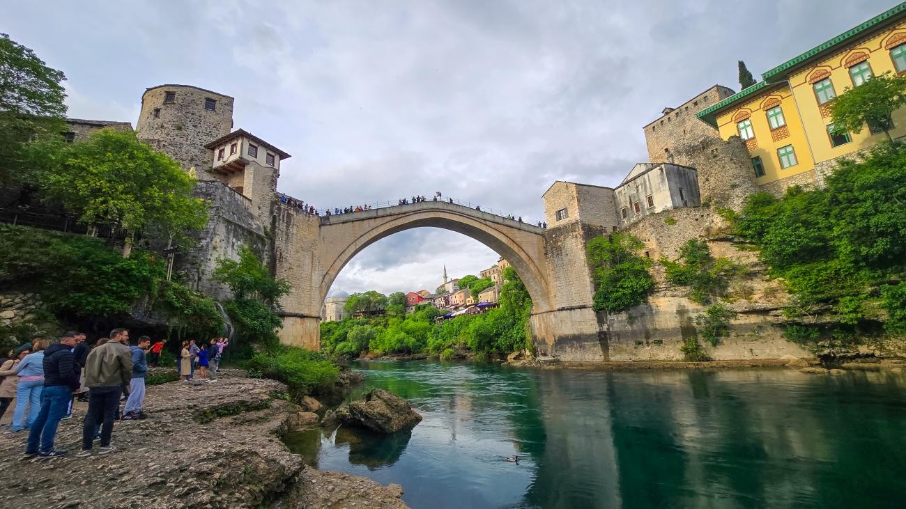 The iconic Stari Most old bridge arching over the emerald Neretva River in Mostar, Bosnia and Herzegovina.